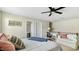 Bright bedroom features a ceiling fan, desk, and seating area for relaxation and comfort at 105 Della St, Chapel Hill, NC 27516