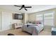 This bedroom is well-lit with a large window, and features a television and bench for relaxing at 105 Della St, Chapel Hill, NC 27516