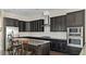 Modern kitchen with stainless steel appliances, granite countertops, and a breakfast bar at 105 Della St, Chapel Hill, NC 27516