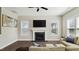 Comfortable living room with hardwood floors, fireplace, and natural light at 105 Della St, Chapel Hill, NC 27516