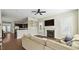 Cozy living area with fireplace, hardwood floors, and adjacent kitchen view at 105 Della St, Chapel Hill, NC 27516