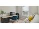 A bright home office featuring modern desk and chair, along with comfortable sofa and natural light at 105 Della St, Chapel Hill, NC 27516