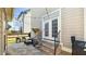 Outdoor patio featuring stone flooring, comfortable seating, string lights, and convenient access to the house at 105 Della St, Chapel Hill, NC 27516