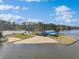 Sandy beach area with a blue building, cars, and lake view at 109 Mohawk Dr, Louisburg, NC 27549