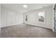 Bedroom with an accent wall and two windows offering views of the outdoors at 109 Mohawk Dr, Louisburg, NC 27549