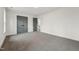 Spacious bedroom featuring plush carpeting, fresh paint, and gray paneled doors at 109 Mohawk Dr, Louisburg, NC 27549