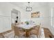 Stylish dining room features modern lighting, panel molding, and a marble-topped table with seating for eight at 109 Mohawk Dr, Louisburg, NC 27549