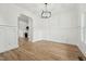 Open dining area with modern panel molding, hardwood floors, and views to the kitchen at 109 Mohawk Dr, Louisburg, NC 27549