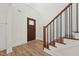 Entryway with wood floors, stairs with iron spindles, and a craftsman style front door at 109 Mohawk Dr, Louisburg, NC 27549
