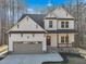 Charming two-story home featuring white siding, a gray roof, and a two car garage at 109 Mohawk Dr, Louisburg, NC 27549