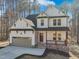 Charming two-story home featuring white siding, a gray roof, and a two car garage at 109 Mohawk Dr, Louisburg, NC 27549