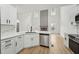 Bright kitchen showcases white cabinets, stainless appliances, and connects to a living area with fireplace at 109 Mohawk Dr, Louisburg, NC 27549