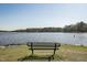 A serene lake view from a park bench invites relaxation and nature appreciation at 109 Mohawk Dr, Louisburg, NC 27549
