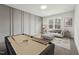 Well-decorated living room features a stylish pool table and comfortable seating area near large windows at 109 Mohawk Dr, Louisburg, NC 27549