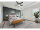 Serene main bedroom featuring a tray ceiling, accent wall, and a plush seating area at 109 Mohawk Dr, Louisburg, NC 27549
