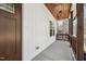 Covered side porch with wood railing, wood-clad ceiling and concrete floor at 109 Mohawk Dr, Louisburg, NC 27549