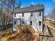 Home featuring a two-story rear elevation with a wood deck and tree-lined backyard at 109 Mohawk Dr, Louisburg, NC 27549