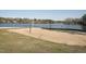 A sandy lakeside volleyball court provides community recreation on a sunny day at 109 Mohawk Dr, Louisburg, NC 27549