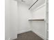 Bright walk-in closet featuring custom shelving and wooden closet rods for optimal organization at 109 Mohawk Dr, Louisburg, NC 27549