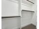 Walk-in closet featuring built-in shelving and wooden hanging rods for optimal storage solutions at 109 Mohawk Dr, Louisburg, NC 27549