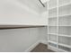 Bright walk-in closet featuring custom shelving and wooden closet rods for optimal organization at 109 Mohawk Dr, Louisburg, NC 27549