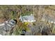 Aerial view of a house with a gray roof, surrounded by trees and other houses in a wooded neighborhood at 1101 Esher Ct, Raleigh, NC 27609