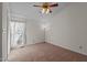 Carpeted bedroom with natural light from the window and a traditional ceiling fan at 1101 Esher Ct, Raleigh, NC 27609