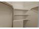 Walk-in closet with multiple levels of shelving and hanging rods, offering ample storage at 1101 Esher Ct, Raleigh, NC 27609