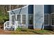 Exterior view with blue siding, white trim, a small porch, and a well-maintained yard at 1101 Esher Ct, Raleigh, NC 27609
