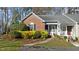 Charming brick exterior of a well-kept townhome with lovely landscaping at 1101 Esher Ct, Raleigh, NC 27609