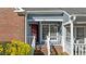 Close up of entrance and covered porch area with red front door at 1101 Esher Ct, Raleigh, NC 27609