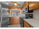 Kitchen showcases stainless steel appliances, wood cabinets, and a pass-through window at 1101 Esher Ct, Raleigh, NC 27609