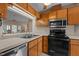 Kitchen showcases stainless steel appliances, wood cabinets, and a pass-through window at 1101 Esher Ct, Raleigh, NC 27609