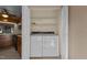 Laundry closet adjacent to kitchen, featuring a full-sized white washer and dryer set at 1101 Esher Ct, Raleigh, NC 27609