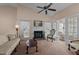 Bright living room boasts a fireplace, neutral carpet, ceiling fan and natural light at 1101 Esher Ct, Raleigh, NC 27609