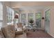 Bright sunroom featuring many windows and comfortable seating at 1101 Esher Ct, Raleigh, NC 27609