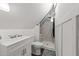 Cozy bathroom with tile shower, glass door, modern fixtures, and crisp white walls at 1106 Aycock Ave, Burlington, NC 27215