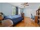 Comfortable bedroom with hardwood floors, a ceiling fan, and ample natural light at 1106 Aycock Ave, Burlington, NC 27215