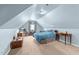 Attic bedroom with blue walls, carpeting, sloped ceilings, and natural light at 1106 Aycock Ave, Burlington, NC 27215