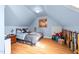 Bedroom with pitched ceilings, hardwood floors, and a comfortable bed at 1106 Aycock Ave, Burlington, NC 27215
