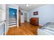 Sunlit bedroom featuring hardwood floors, blue walls, and classic furnishings at 1106 Aycock Ave, Burlington, NC 27215