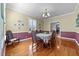 Bright dining room with wainscoting, hardwood floors, and a chandelier at 1106 Aycock Ave, Burlington, NC 27215