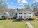 Spacious traditional home with white exterior, a covered front porch, and lovely landscaping at 1106 Aycock Ave, Burlington, NC 27215
