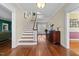Elegant foyer with hardwood floors, staircase, and a view of French doors at 1106 Aycock Ave, Burlington, NC 27215