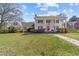Stately two-story home with white columns, a red front door, and a brick walkway at 1106 Aycock Ave, Burlington, NC 27215