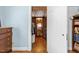 Hallway leading from bedroom with closet, bookshelves and hardwood floors at 1106 Aycock Ave, Burlington, NC 27215