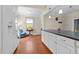 Bright eat-in kitchen features a large island, hardwood floors, and lovely natural light at 1106 Aycock Ave, Burlington, NC 27215