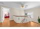 Upstairs landing with staircase, hardwood floors, ceiling fan, and access to bedrooms at 1106 Aycock Ave, Burlington, NC 27215