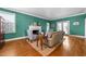 Cozy living room with a fireplace, neutral furniture, and hardwood floors at 1106 Aycock Ave, Burlington, NC 27215