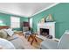 Comfortable living room with a marble fireplace, nautical decor, and large windows at 1106 Aycock Ave, Burlington, NC 27215